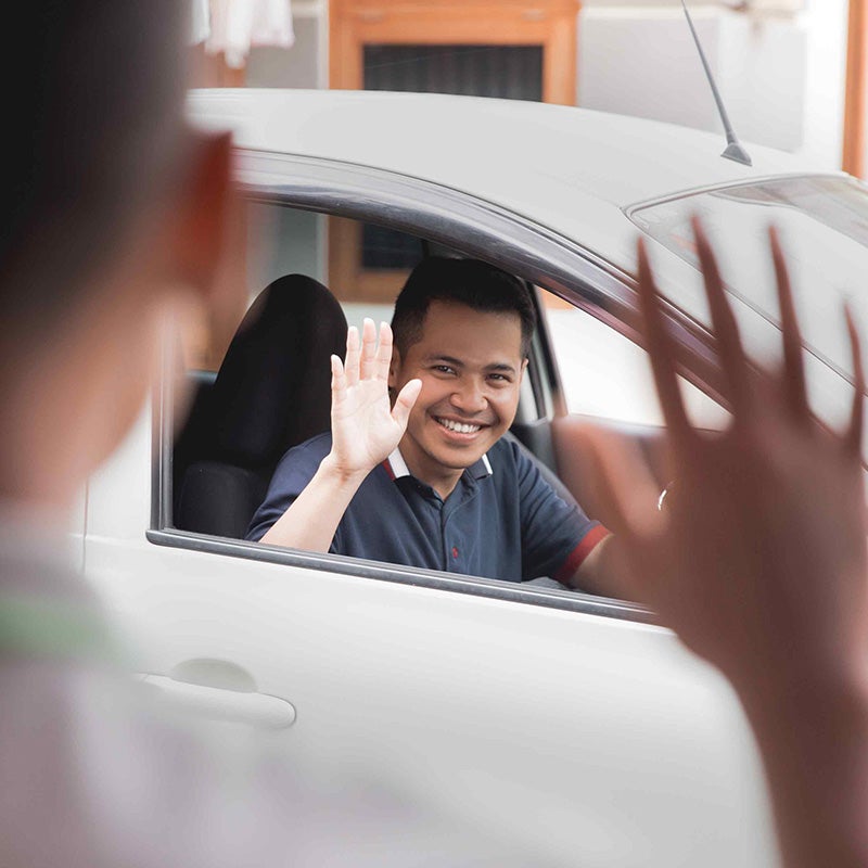 Merced Chevrolet in Merced CA customer waving at sales rep