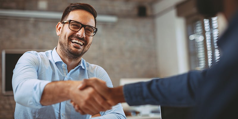 Merced Chevrolet in Merced CA customer shaking sales rep hands